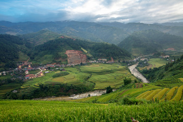 Fototapeta na wymiar Farming village surrounded by mountains.