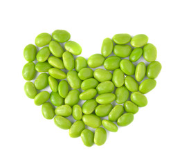 Green soybeans with heart shape on white background