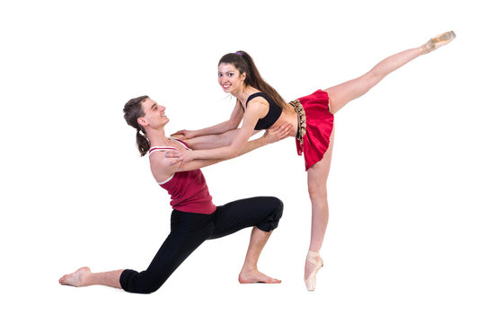 Full length of young ballet couple dancing on white background
