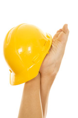 woman legs up with a construction hat on one foot