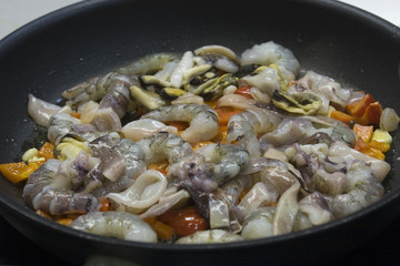 Cooking Spanish paella with seafood