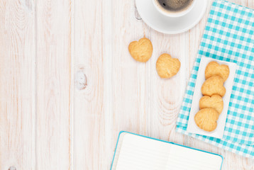 Coffee, heart shaped cookies and notepad