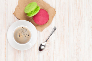 Coffee cup, colorful macarons and spoon