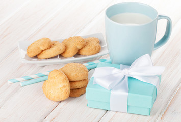 Cup of milk, heart shaped cookies and gift box