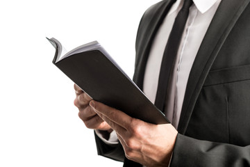 Businessman reading from a notebook