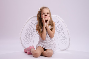 Seated girl with angel wings