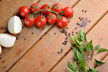 Preparation of Italian food on wood - onions, tomatoes, basil.
