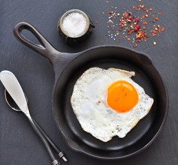 Breakfast the fried egg in a iron frying pan