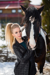 Obraz premium Young young girl goes on a brown horse