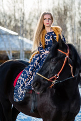 Obraz premium Young young girl goes on a brown horse