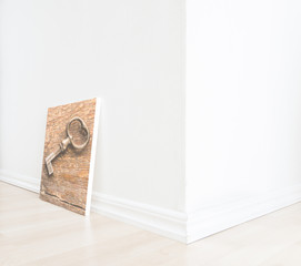 Empty room interior with art on floor