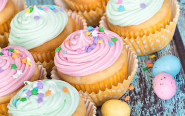 Pastel Easter cupcakes with candy and sprinkles