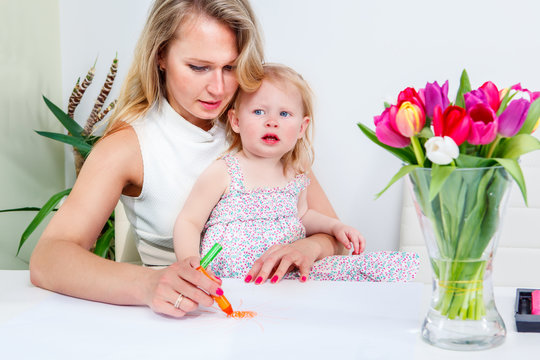 Mother and daughter drawing a picture