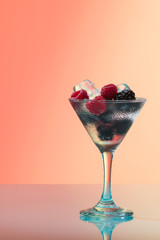 Raspberry and blackberry cocktail with ice, studio shot