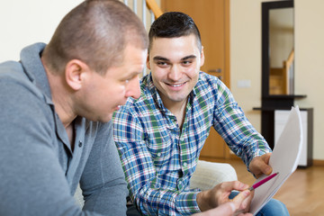 Agent and client with documents at home