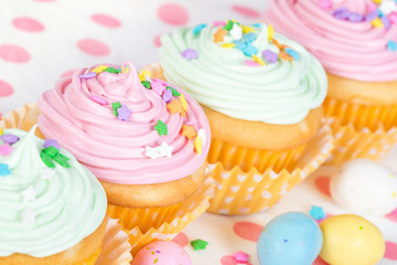 Pastel Easter cupcakes with candy and sprinkles