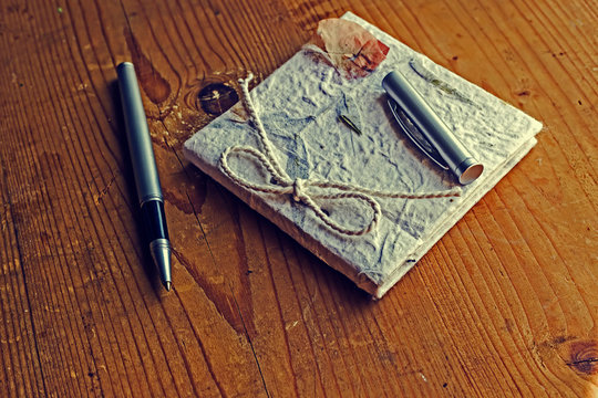 Old diary memories with pen on a wooden table