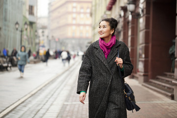 Young Asian woman walking on spring city in Russia