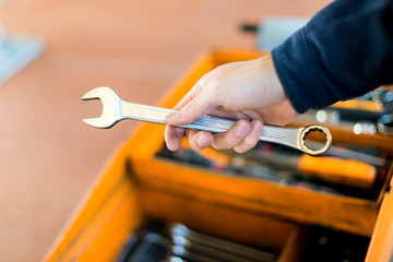 Mechanic hand holding a wrench