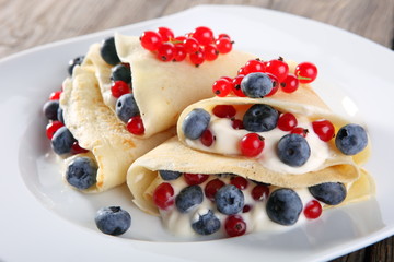 Pancakes with cream and fresh blueberries