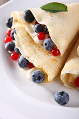 Pancakes with cream and fresh blueberries