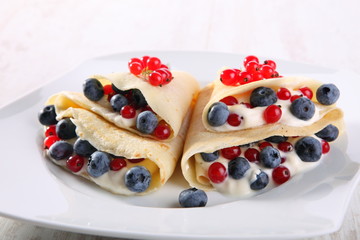 Pancakes with cream and fresh blueberries