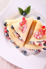 Pancakes with cream and fresh blueberries