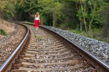 Girl walking on rails