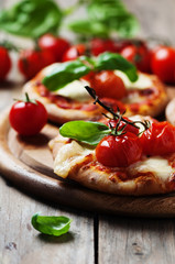 Mini pizza with mozzarella and tomato