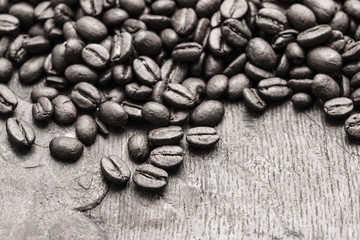 Roasted coffee beans on a rustic old wooden table