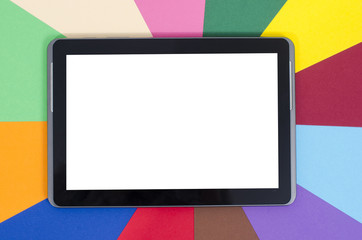 Blank tablet with white screen on rainbow color background.