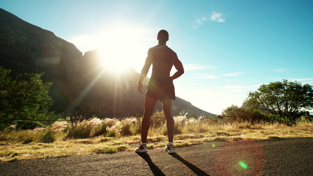 Fit joyful athlete leaping into the air in triumph slow motion
