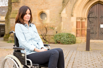 a young woman in a wheelchair looking sad