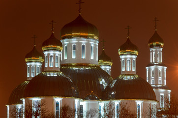 Obraz premium Church in the night city. Glitter gilded domes.