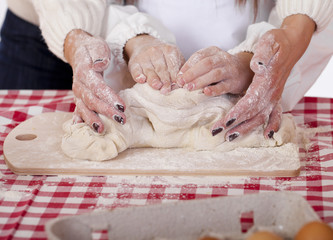 Close up hands of family are baking cakes in home kitchen