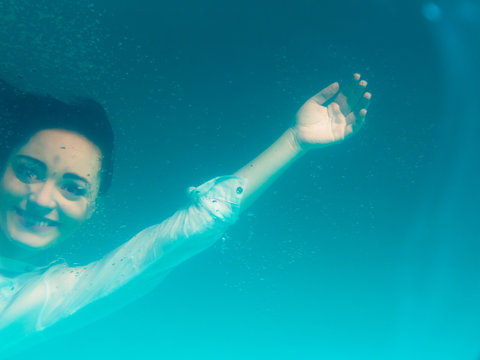 Underwater girl wearing bikini in swimming pool