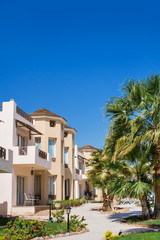Fototapeta premium Bright Egyptian hotel building and plants