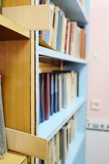 Books in a row. Bookshelf in public library.
