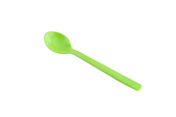 Green plastic spoon isolated on white.