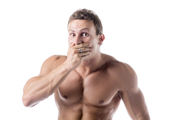 Naklejka premium Young man covering mouth with hand, not laughing