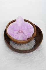 bowl of blue orchid with many salt on towel