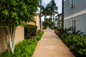 Gardens and houses along walkway, on Lido Isle, in Newport Beach