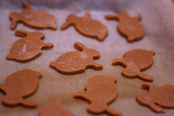 Bunny shaped gingerbread cookies in an oven pan, before baking.