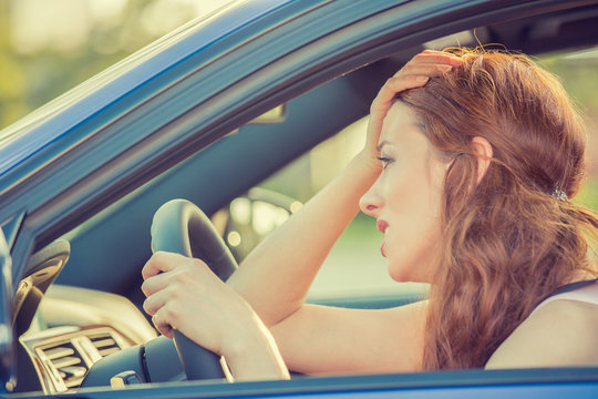 young stressed angry pissed off woman driving car annoyed