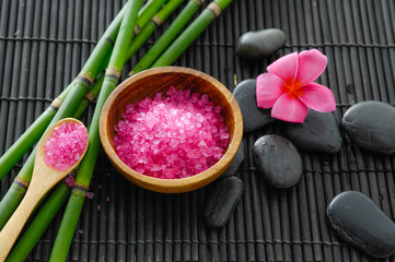 Obraz na płótnie Canvas Spa setting with pink frangipani ,bamboo grove, stone salt in bowl