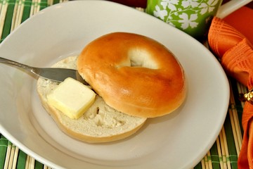 A bagel with a pat of butter 