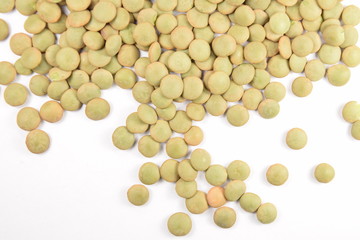 Green lentils on a white background.