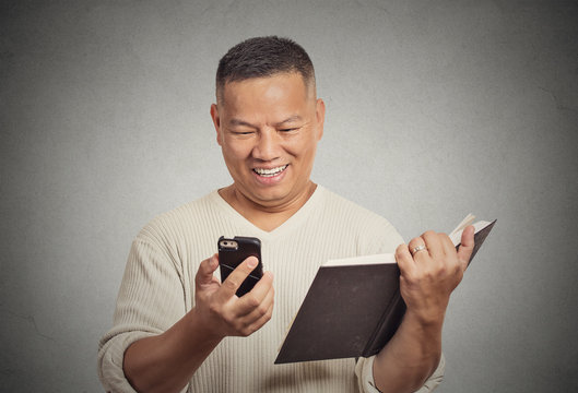 happy middle aged man reading funny news on smart phone