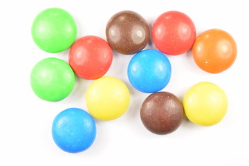 Colorful candies spread on white background.