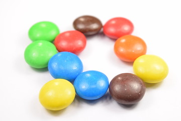 Colorful candies spread on white background.